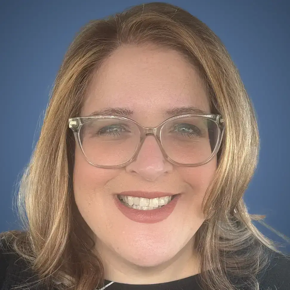 Heather Davis Lam professional headshot with glasses and blue background